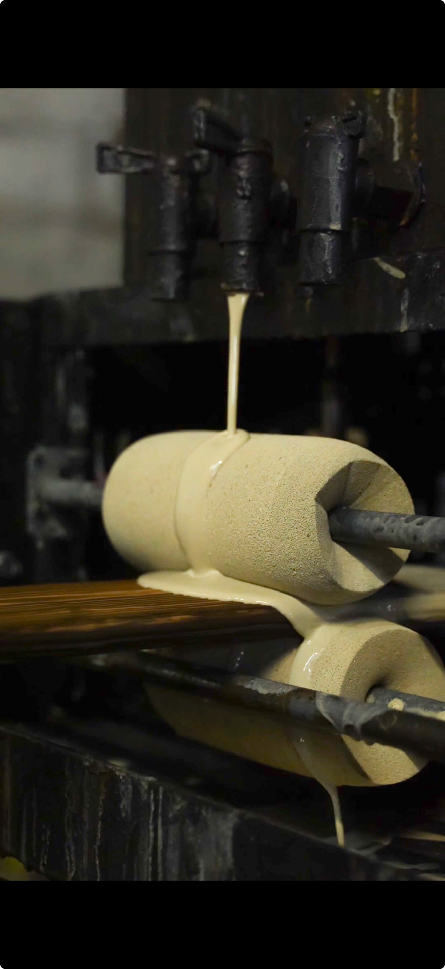 Oil being applied to timber with rollers at the Inflamed factory