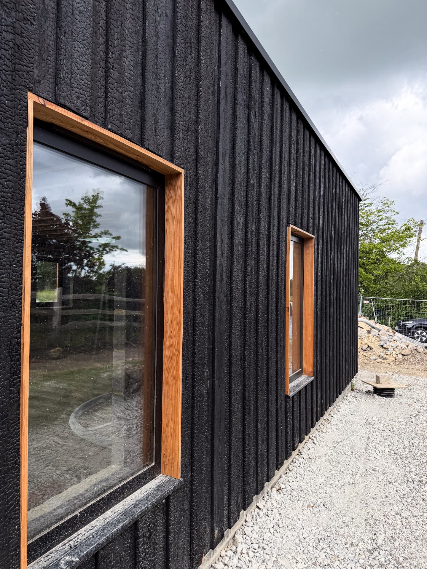 Charred timber facade weathering on a completed building